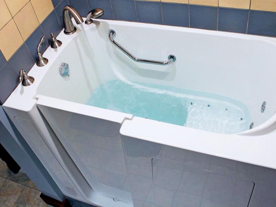 A stunning blue bathroom with a freestanding bathtub, walk-in